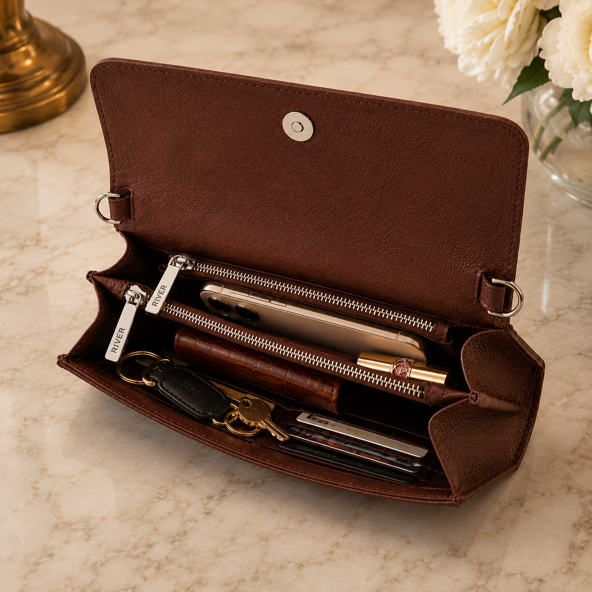 Capacity view of The Cavendish genuine caiman leather shoulder clutch, showing organized space for a phone, keys, lipstick, cards, and a slim wallet inside its full-grain leather interior.