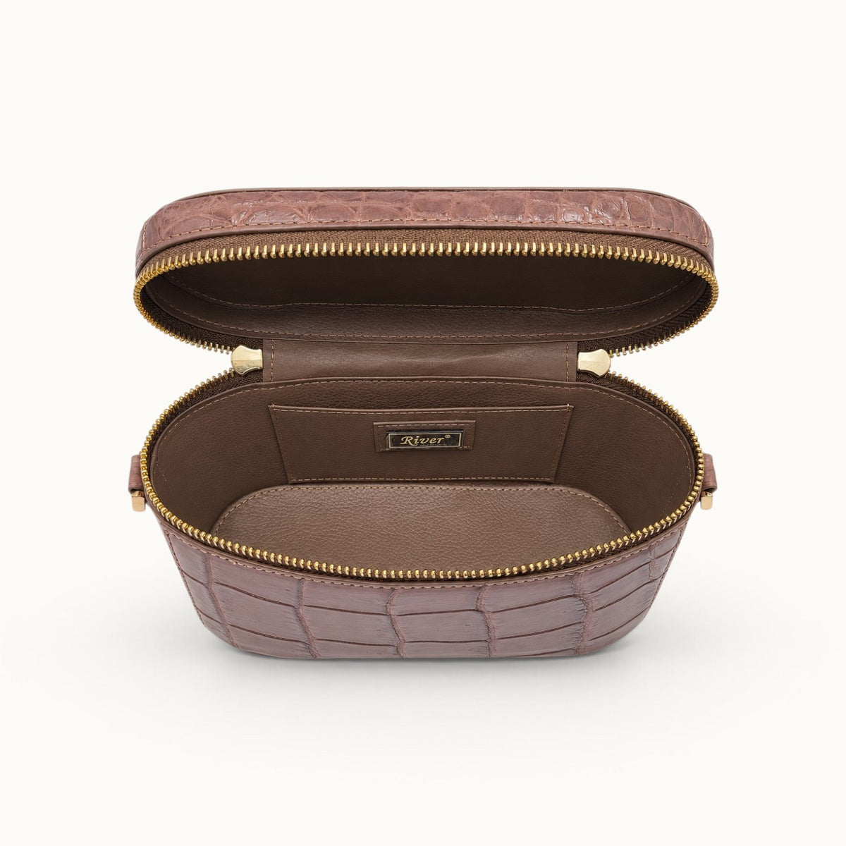 Interior view of The Clarendon Mini Box Bag in Cocoa Brown featuring genuine Siamese crocodile leather, full-grain cow leather interior, structured vanity case design, double zipper pulls, and organized slip pockets.