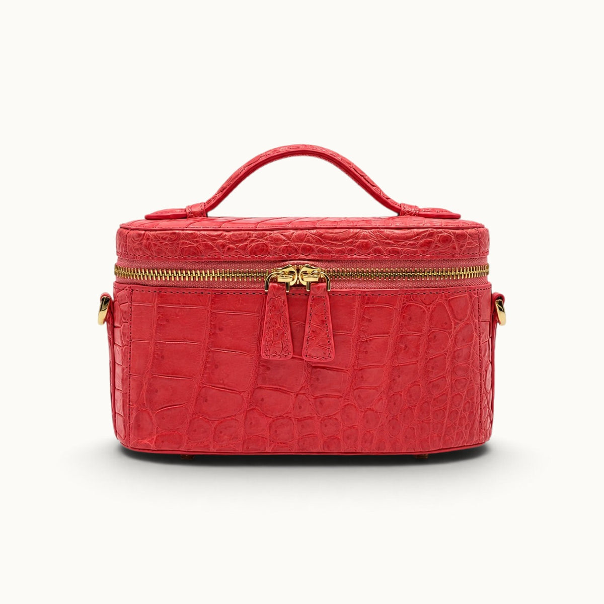 Front view of The Clarendon Coral Red crocodile mini box bag with bright exotic leather and polished gold-tone hardware.