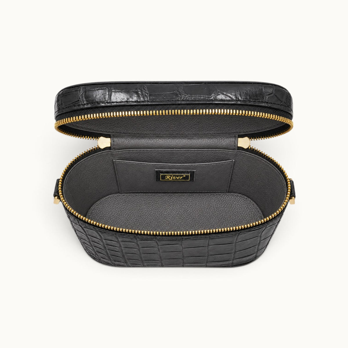 Interior view of The Clarendon Mini Box Bag in Gunmetal Gray, a luxury genuine Siamese crocodile mini box bag with full-grain cow leather lining, double zipper closure, and practical interior slip pockets.