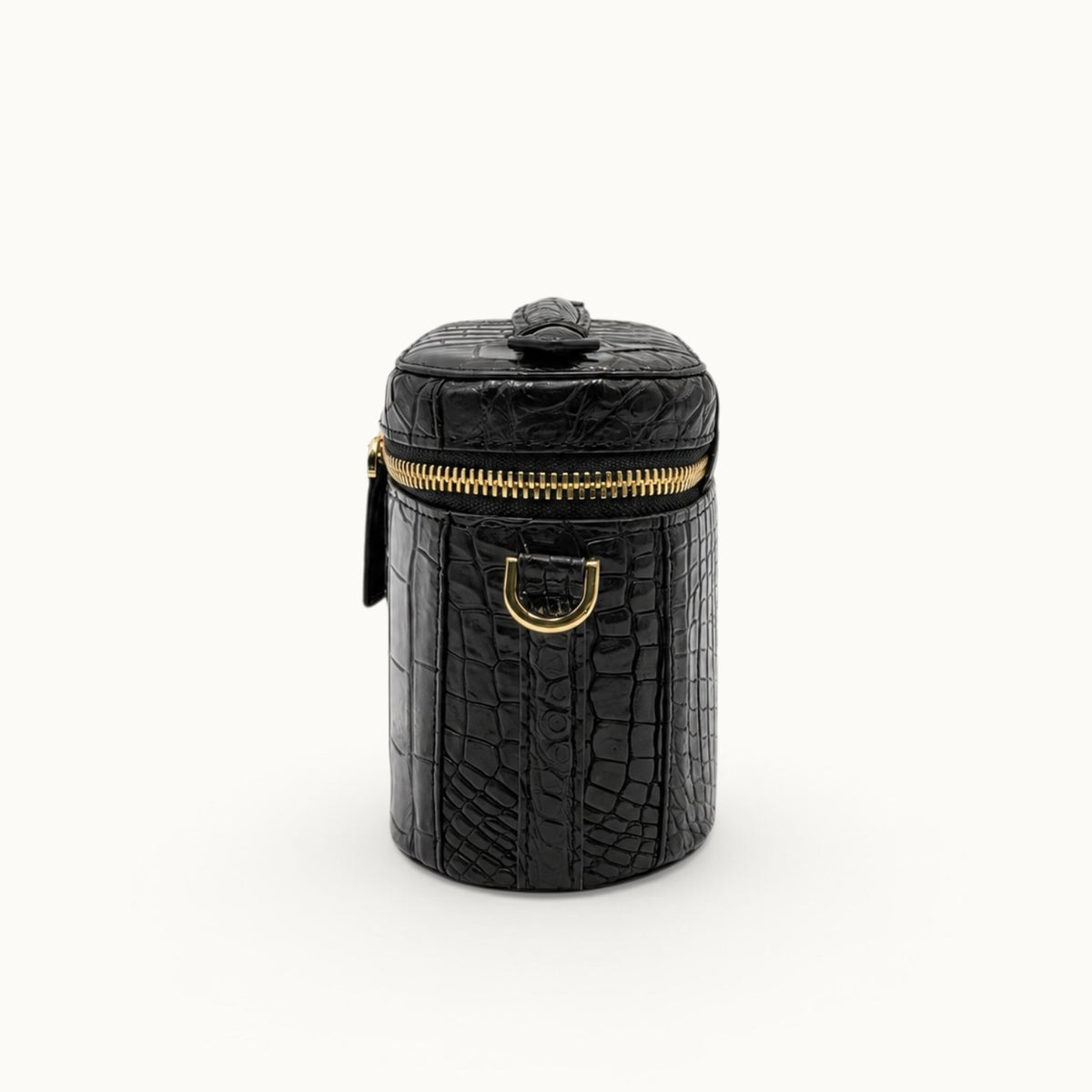 Side profile of a Classic Black crocodile crossbody mini handbag with removable strap attachment and gold-tone D-ring.