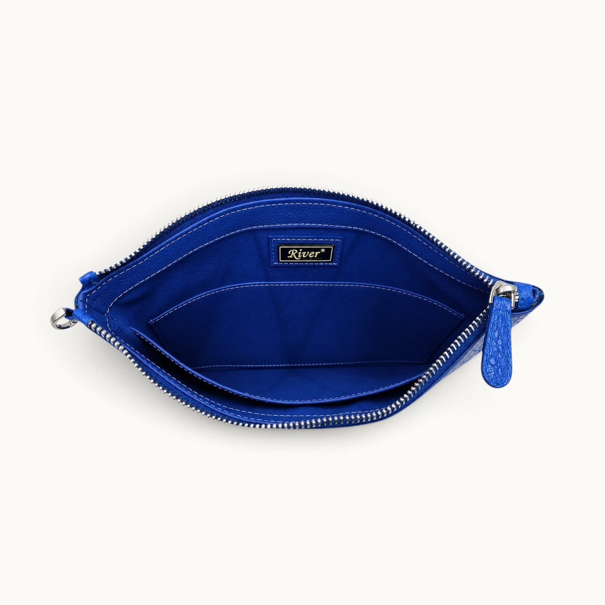 Royal blue crocodile clutch with matching full-grain leather interior, slip pocket and zip closure