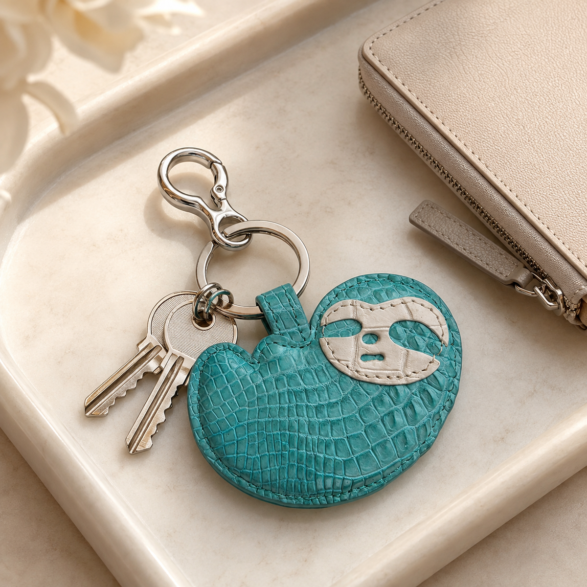 Seafoam Green Crocodile Palette Bag Charm with keys styled on a refined tray beside a neutral leather wallet
