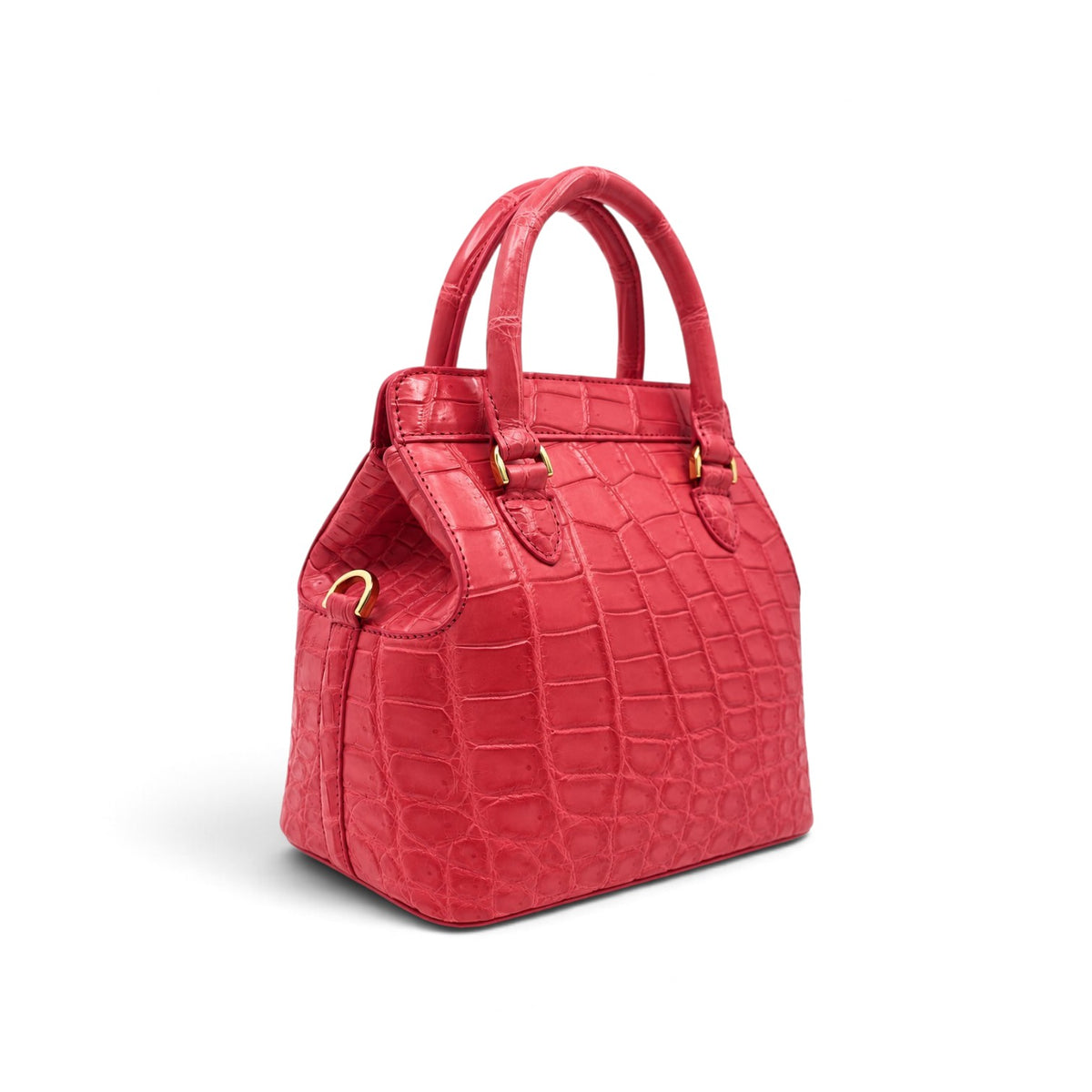 Three-quarter studio view of The Ellery Crocodile Handbag in Coral Pink, highlighting its structured silhouette, crocodile leather texture, and gold-tone hardware.