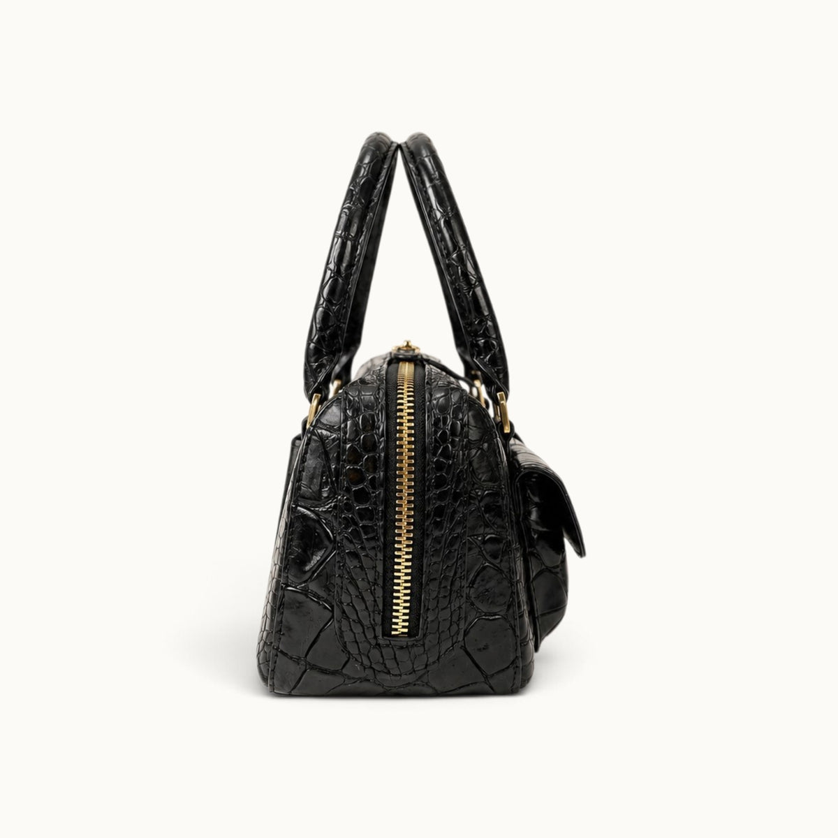 ide view of the Fairmont Siamese crocodile handbag in Classic Black showing its structured profile, top zipper, and handles.