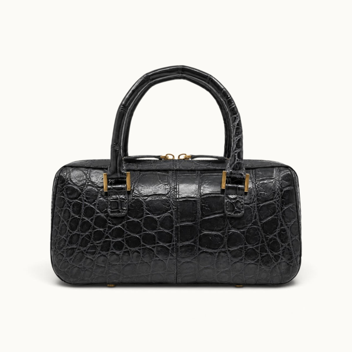 Back view of The Fairmont Crocodile Handbag in gunmetal showing natural crocodile scale texture, structured top handles, gold-tone hardware, and protective feet.
