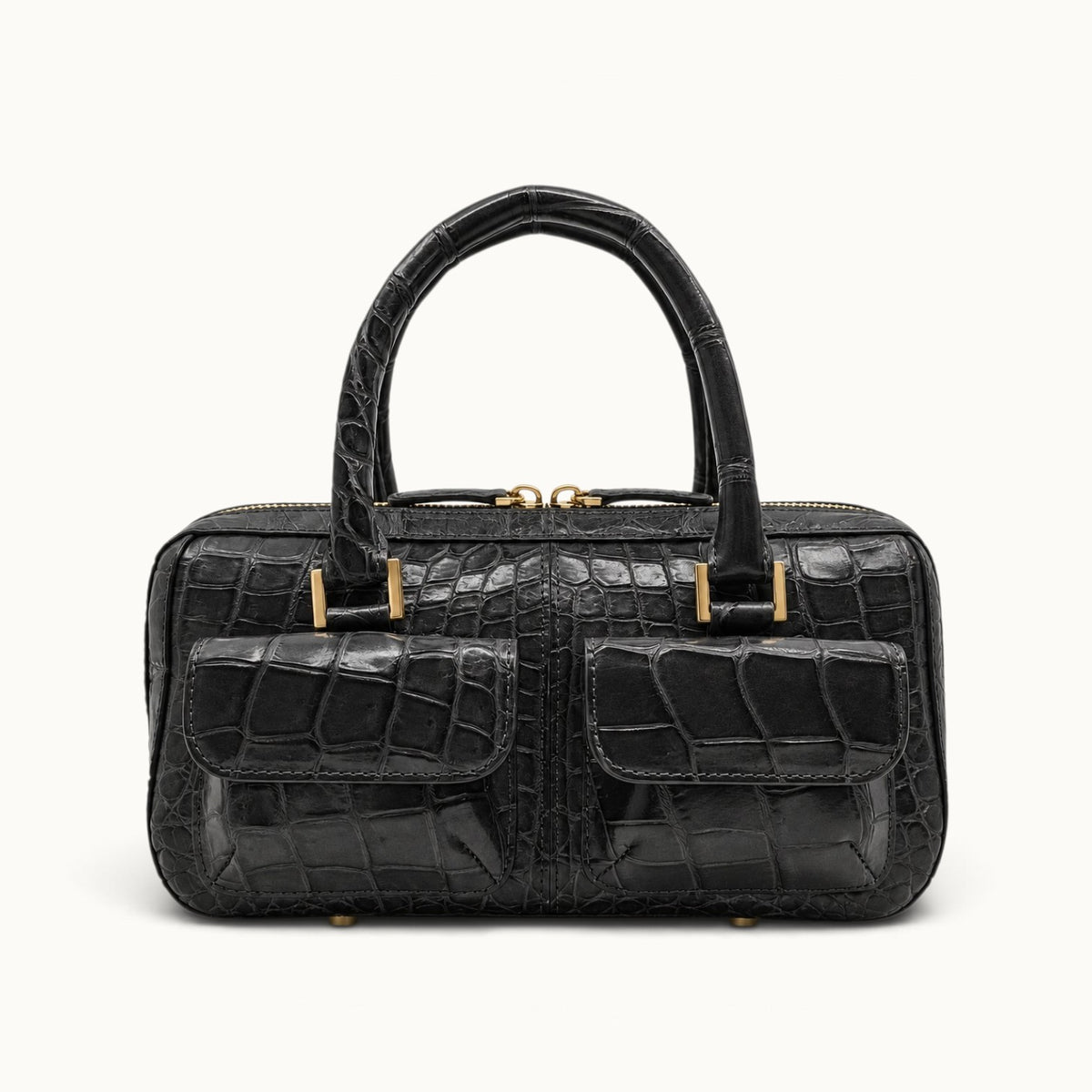 The Fairmont Crocodile Handbag in gunmetal, front view with dual flap pockets, structured top handles, and polished gold-tone hardware.