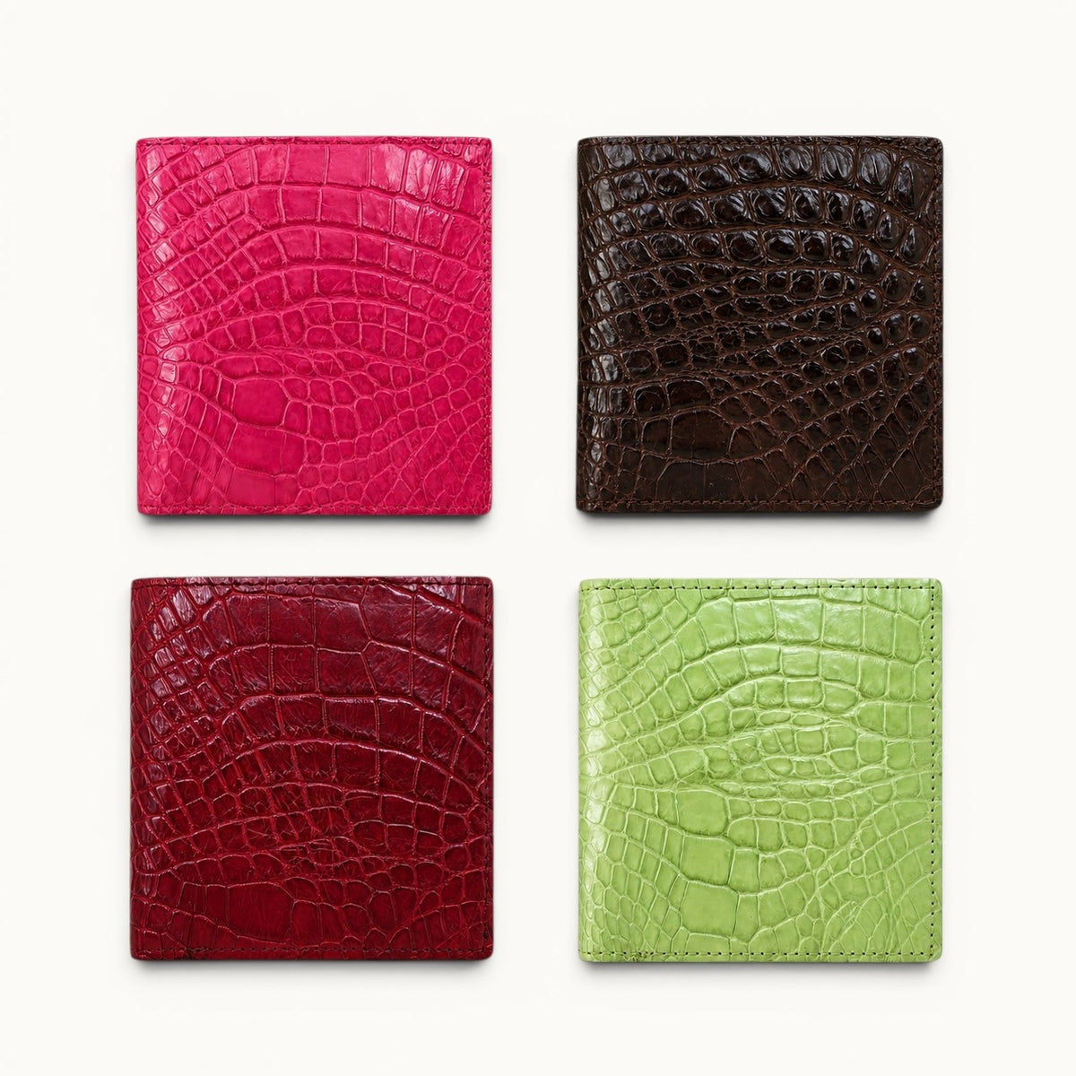 Herrington genuine Siamese crocodile trifold wallets shown in Bright Pink, Espresso Brown, Cherry Red, and Lime Green.