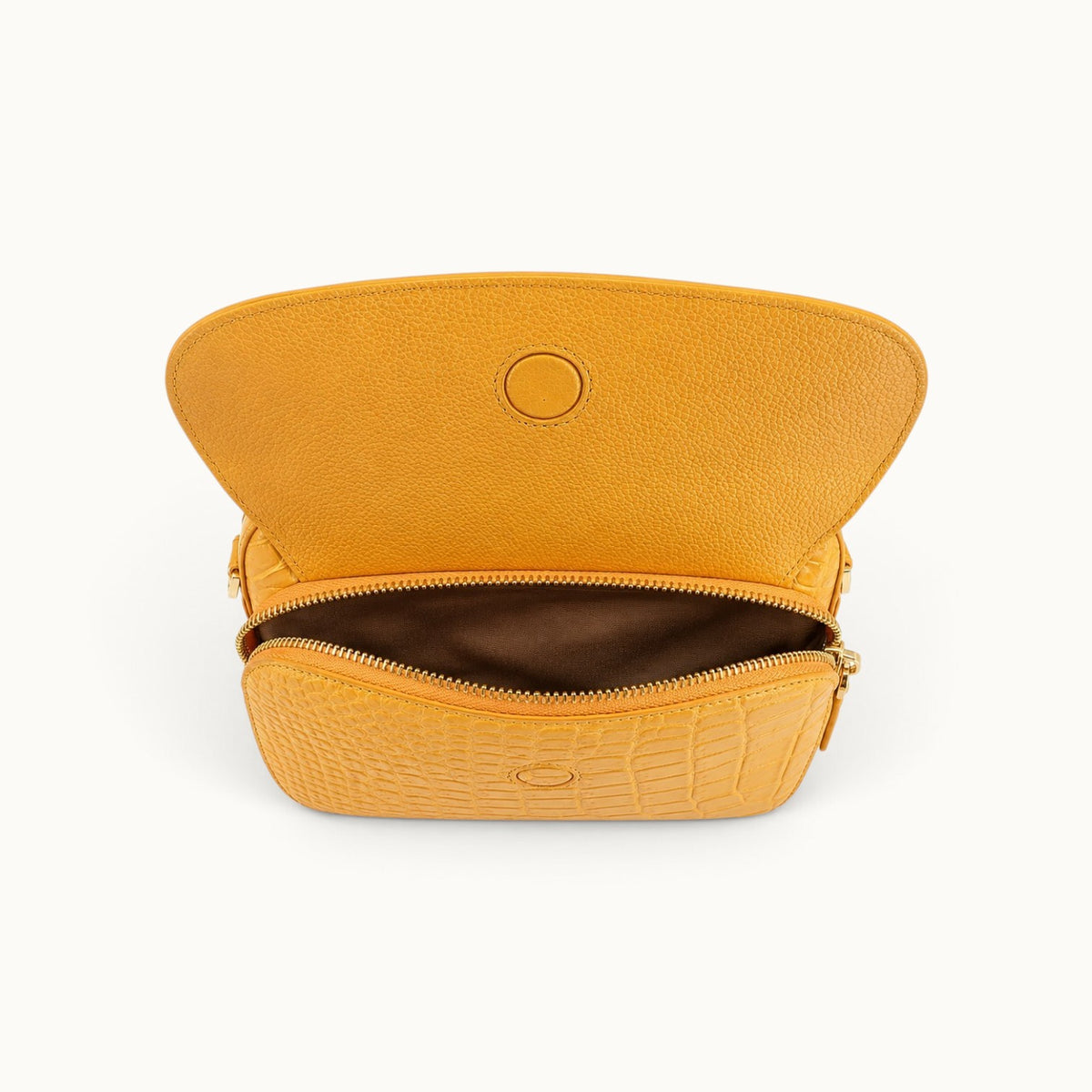 Grosvenor Siamese crocodile crossbody bag with the front zippered compartment open beneath the magnetic flap.