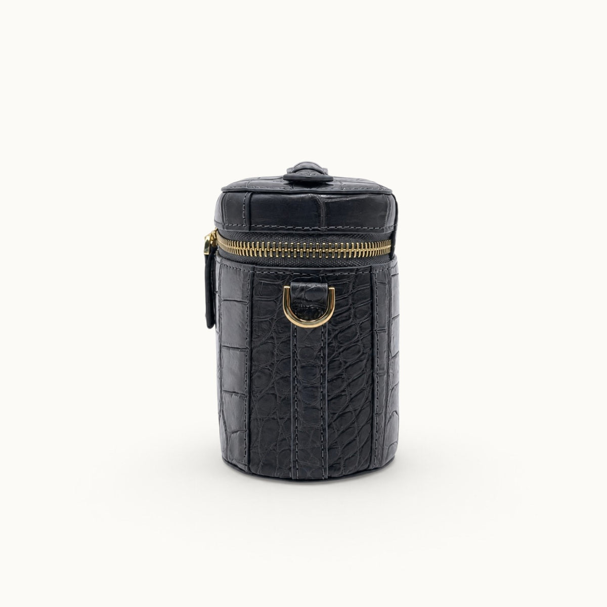 Side view of a Gunmetal Gray crocodile shoulder and crossbody bag with gold-tone strap ring and compact box profile.