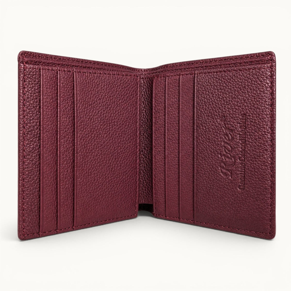 Herrington Cherry Red trifold wallet open to reveal a full-grain cow leather interior with six card slots, dual cash compartments, and embossed River branding.