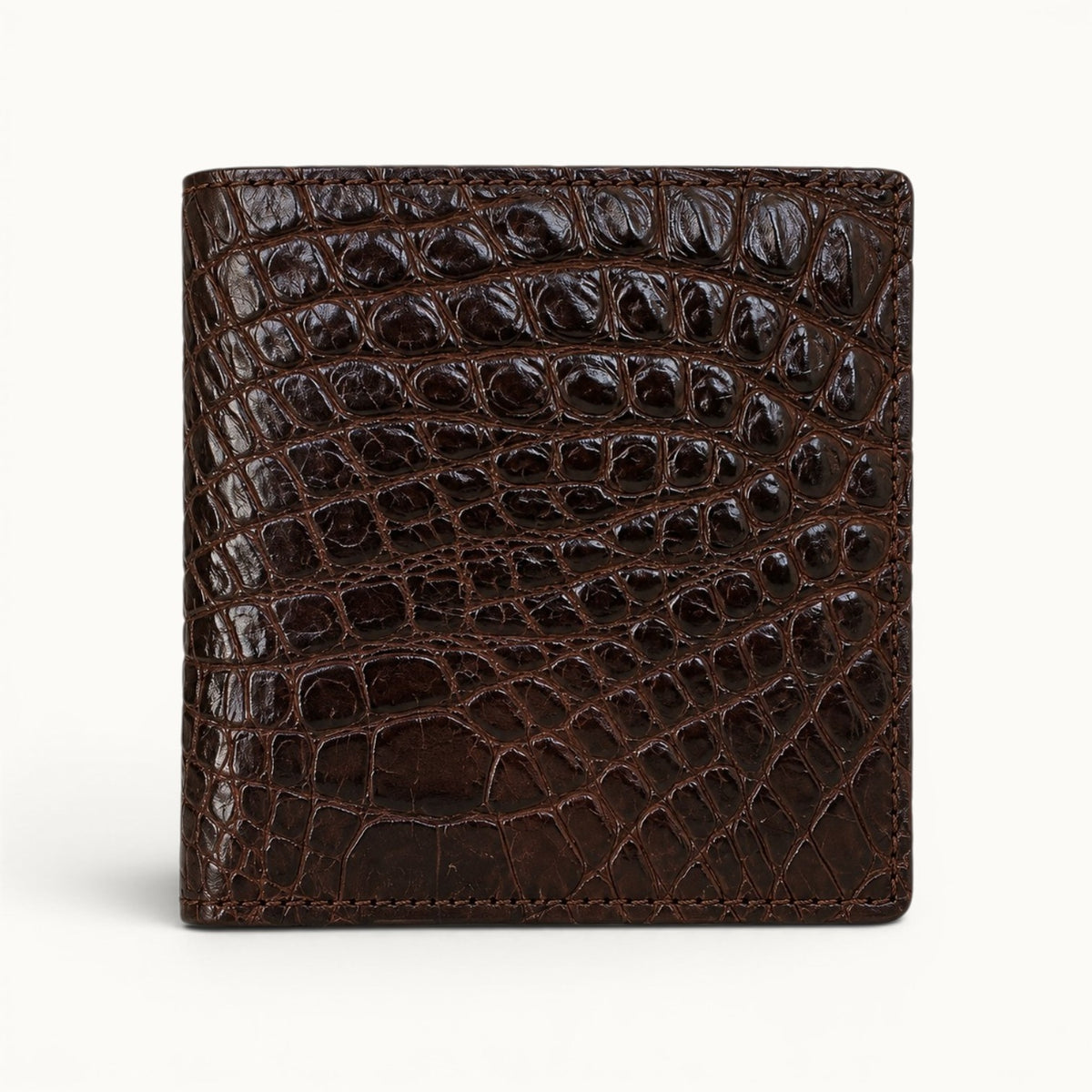 Herrington Espresso Brown trifold wallet crafted from genuine Siamese crocodile leather, shown in a straight front view with a bold natural scale pattern.