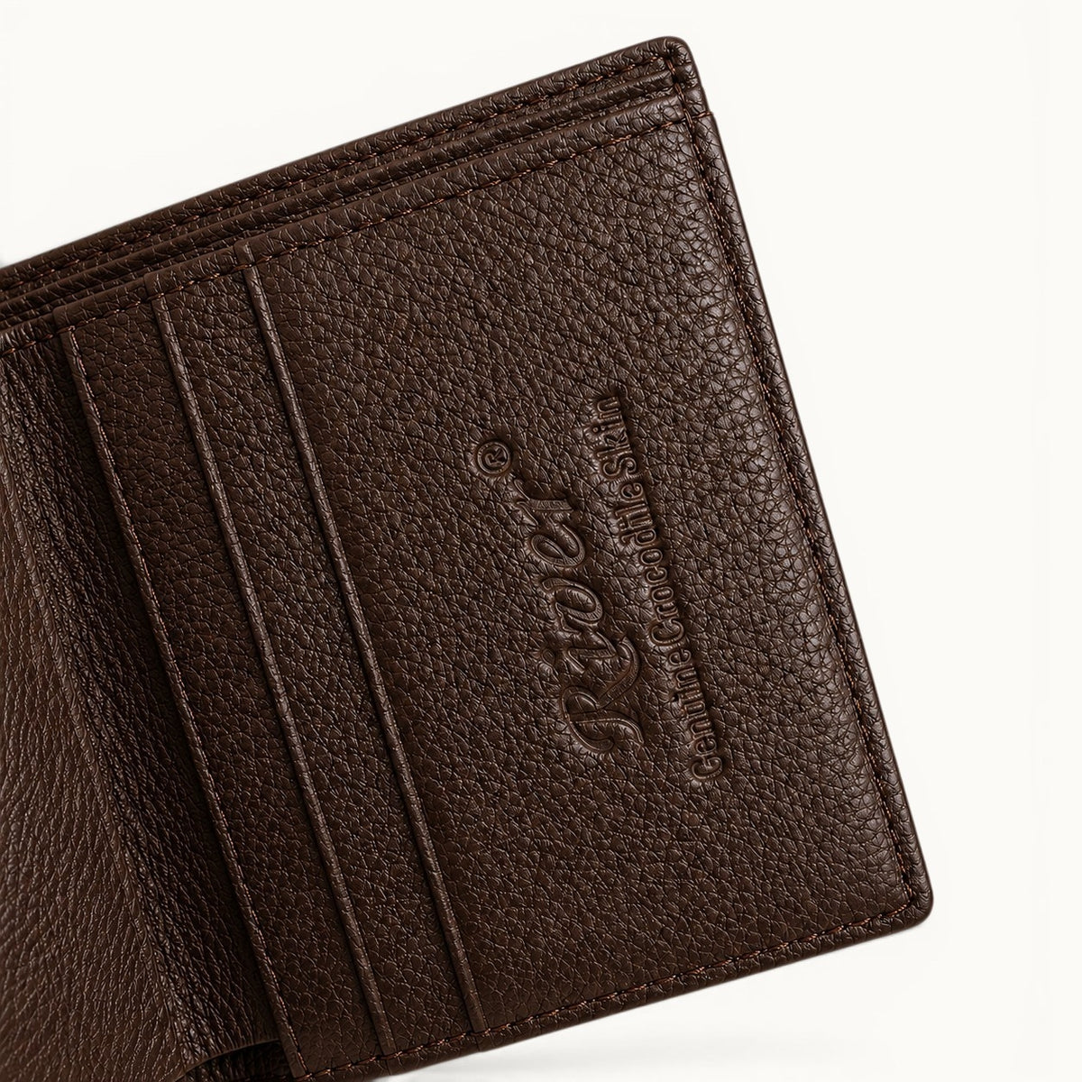 Close-up of The Herrington Espresso Brown trifold wallet, highlighting the full-grain cow leather interior, embossed River branding, fine stitching, and card-slot craftsmanship.