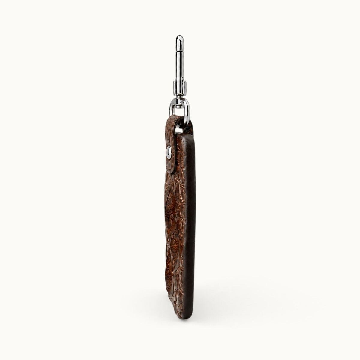 Side profile of the Kensington brown alligator leather key fob showing its slim construction, dark hand-finished edge, raised scale texture, and polished silver clasp.