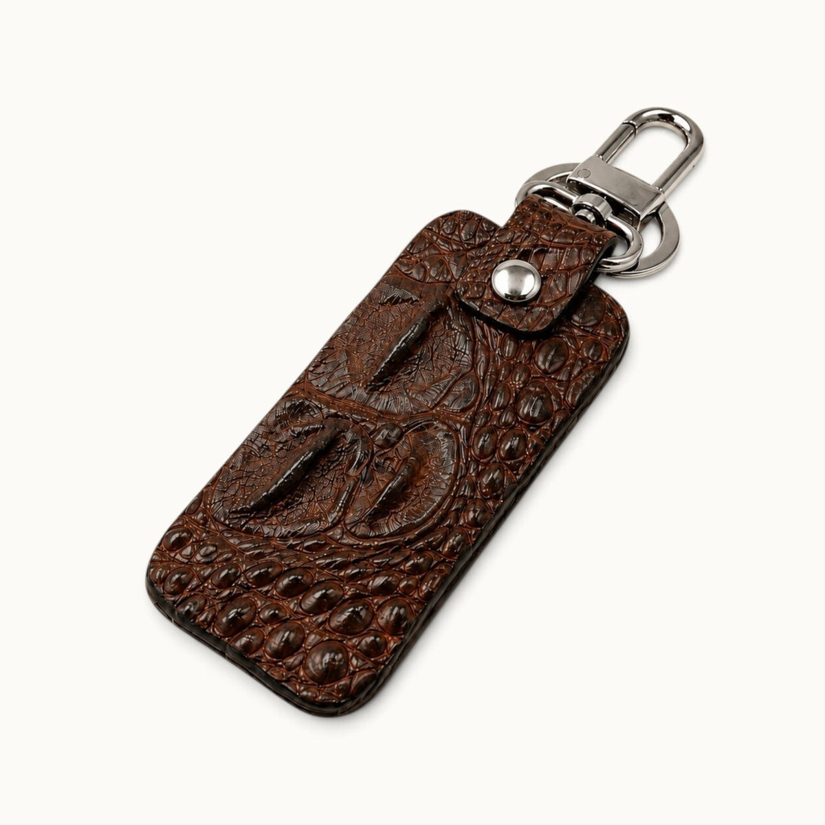 Angled view of the Kensington genuine brown alligator leather keychain with raised hornback scales, silver swivel clasp, and large key ring.
