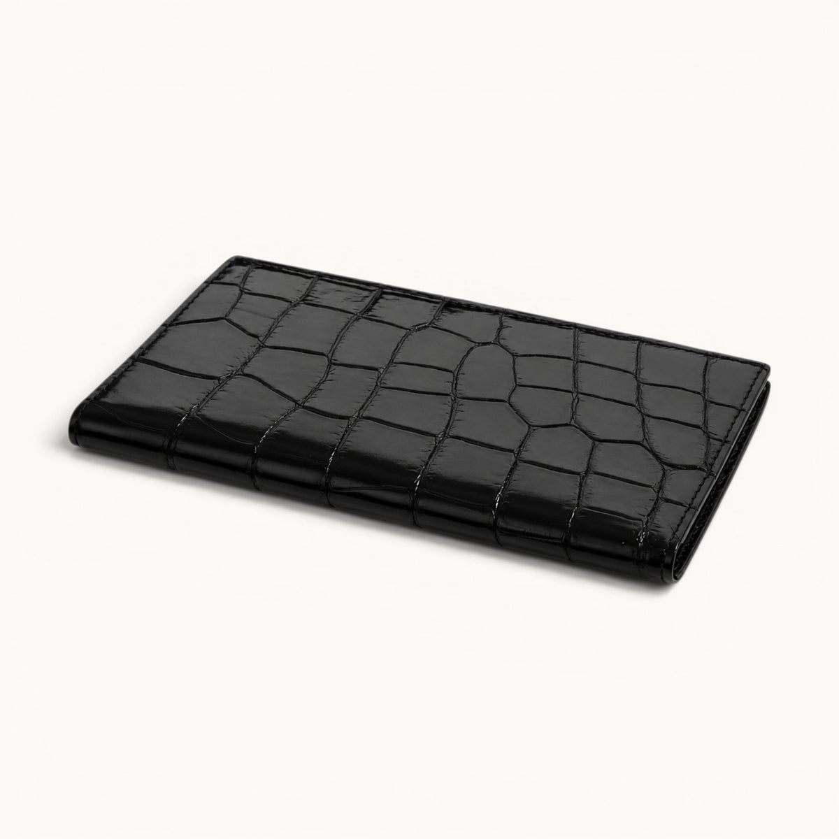 Closed flat view of The Kingsley Crocodile Long Wallet in genuine crocodile leather.