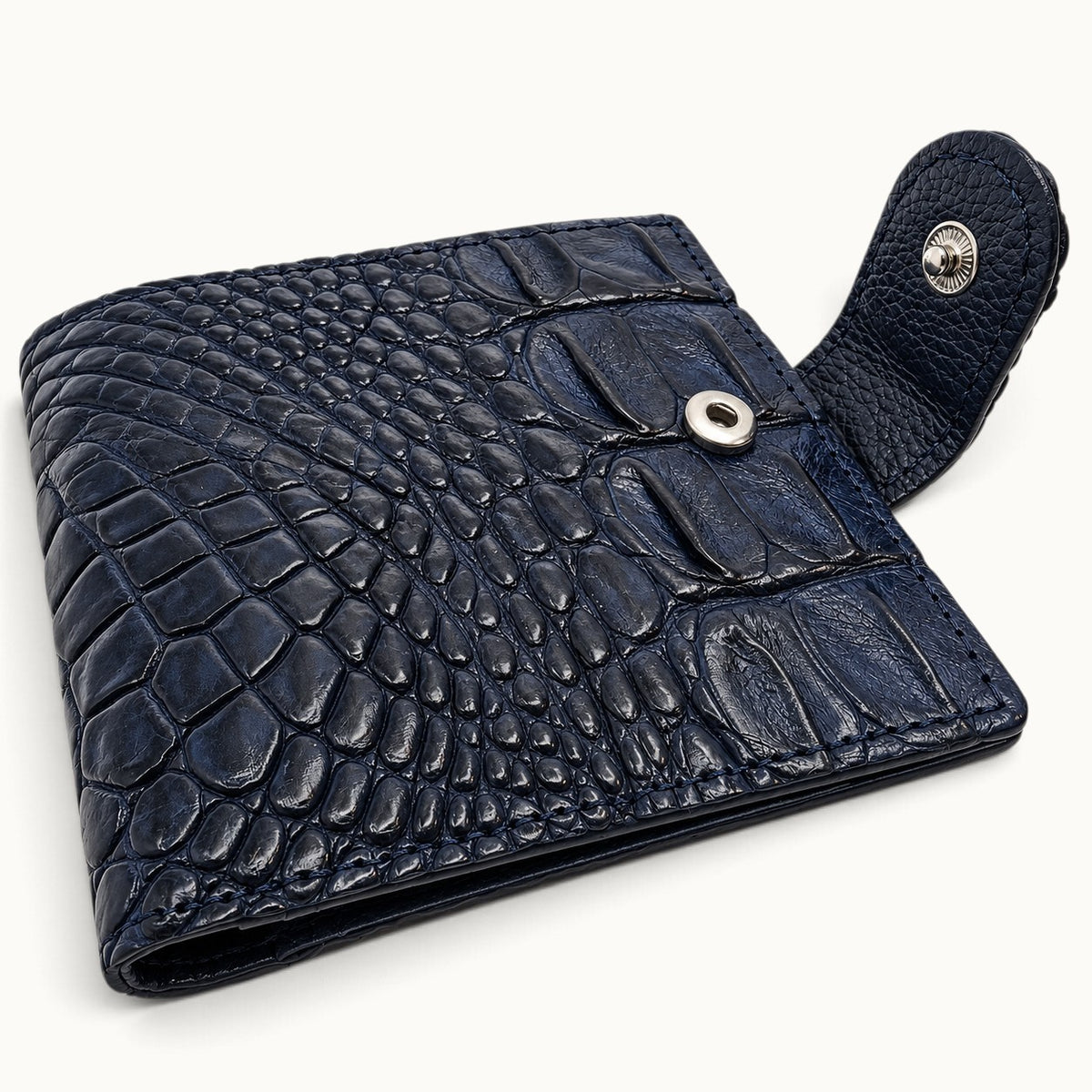 Deep navy Langham crocodile wallet detail showing snap closure, silver hardware, and crocodile leather texture