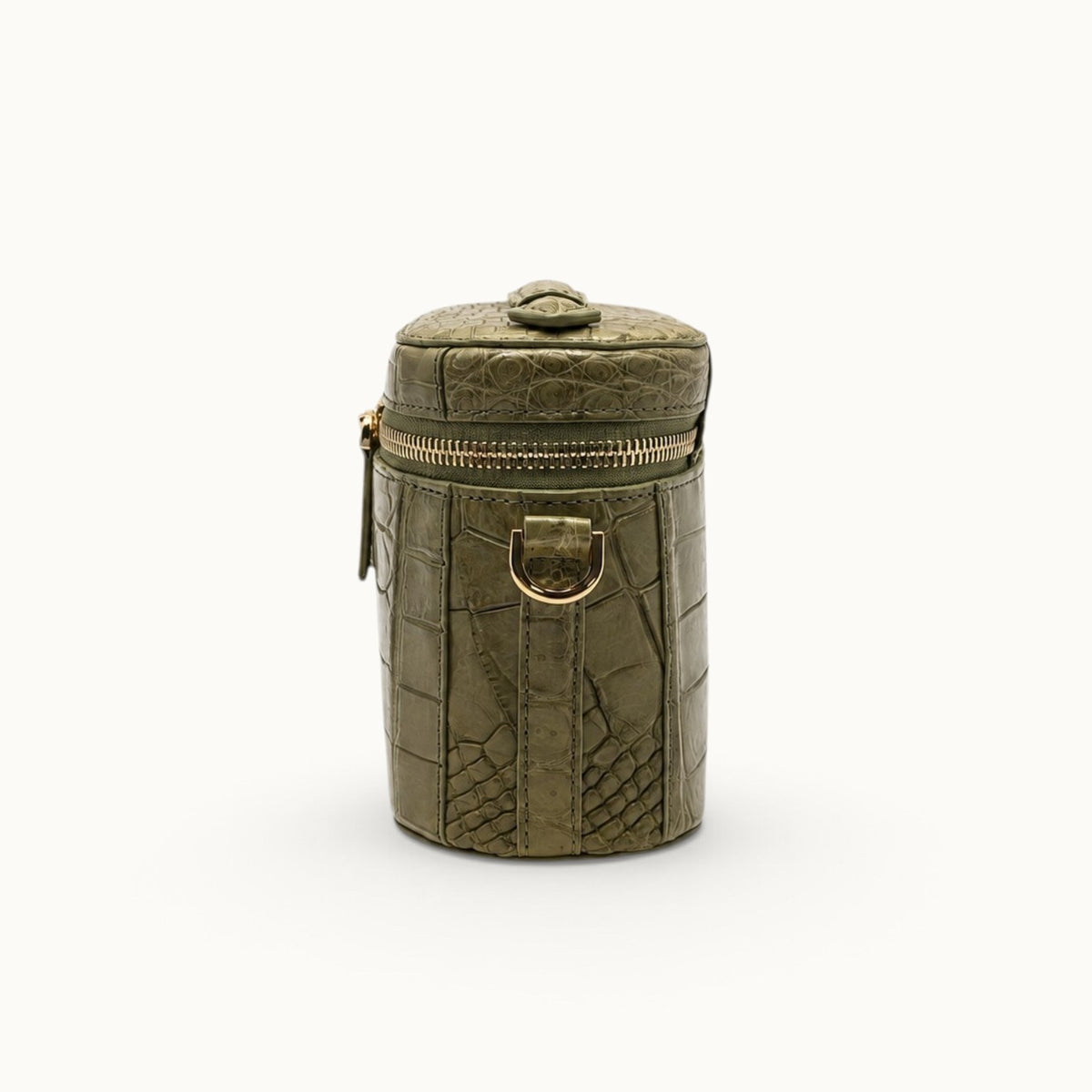 Side profile of a Sage Olive crocodile crossbody box bag showing the gold-tone D-ring and compact structured depth.