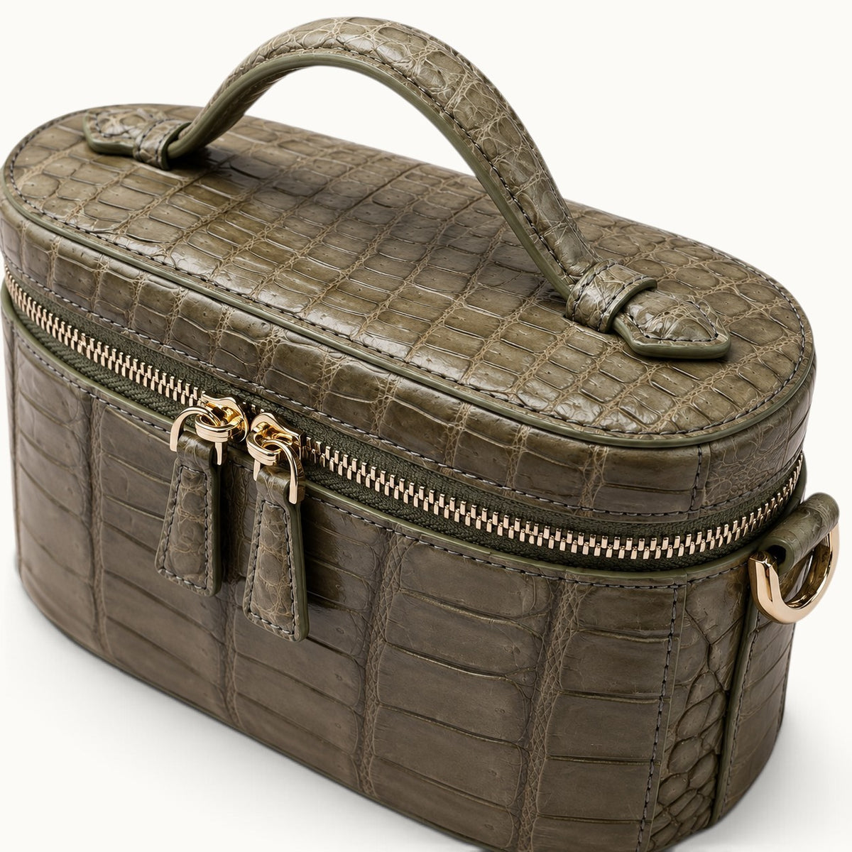 Close-up of genuine Sage Olive Siamese crocodile leather showing natural scales, hand-finished stitching and luxury craftsmanship.