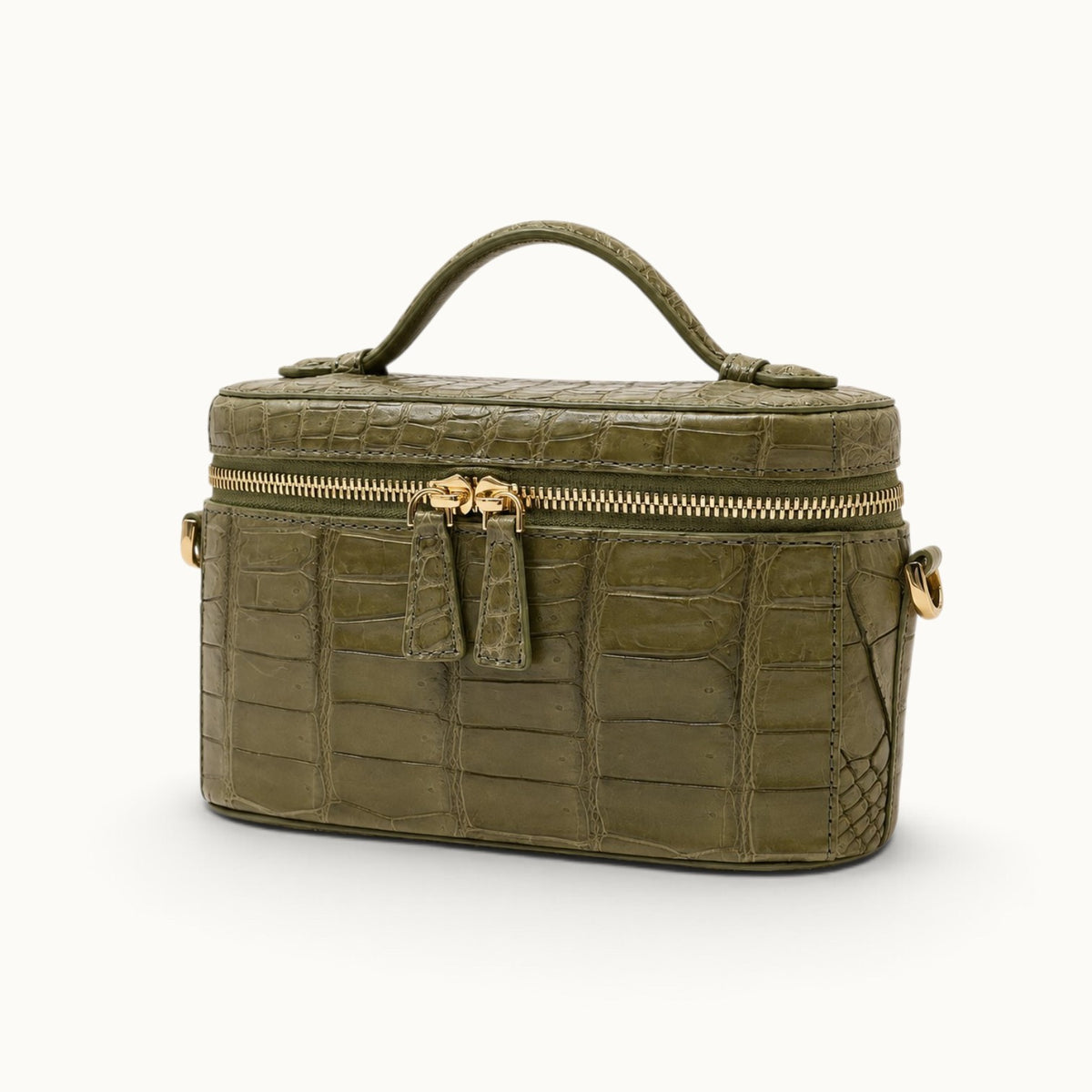 Three-quarter angle of a Sage Olive luxury crocodile top handle handbag with structured mini vanity case silhouette.