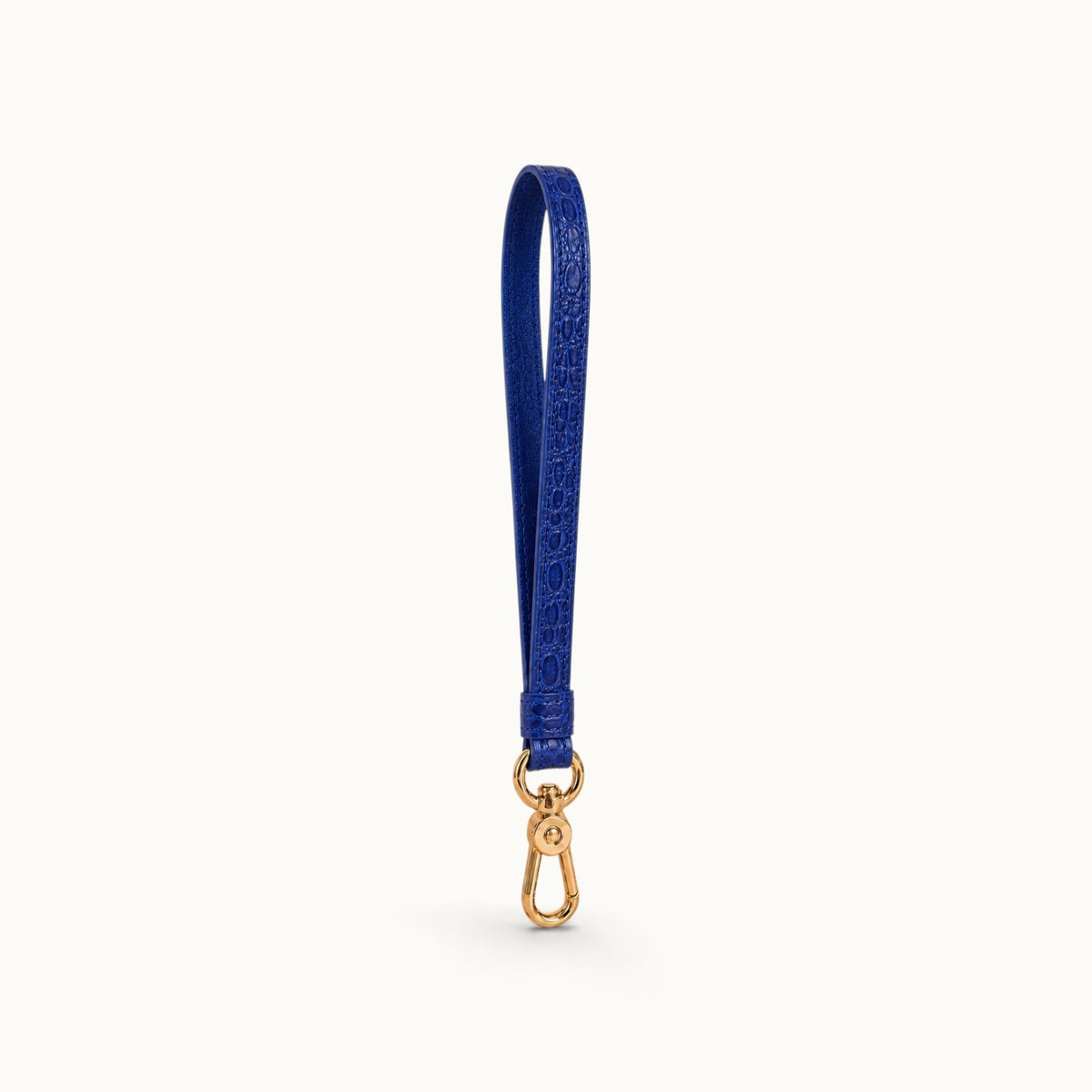 Angled view of the Royal Blue Stanhope crocodile wrist strap showing the crocodile texture, cow leather interior, and gold-tone clasp.
