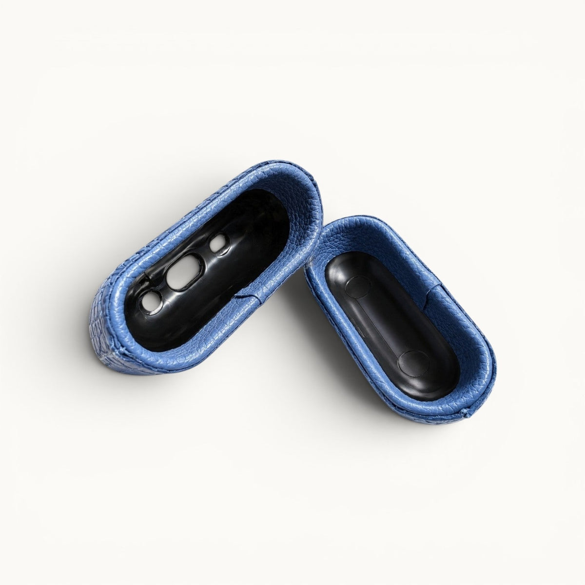 Open interior view of The Crocodile AirPods Case in French Blue handcrafted from genuine Siamese crocodile leather with a precision-molded protective shell.