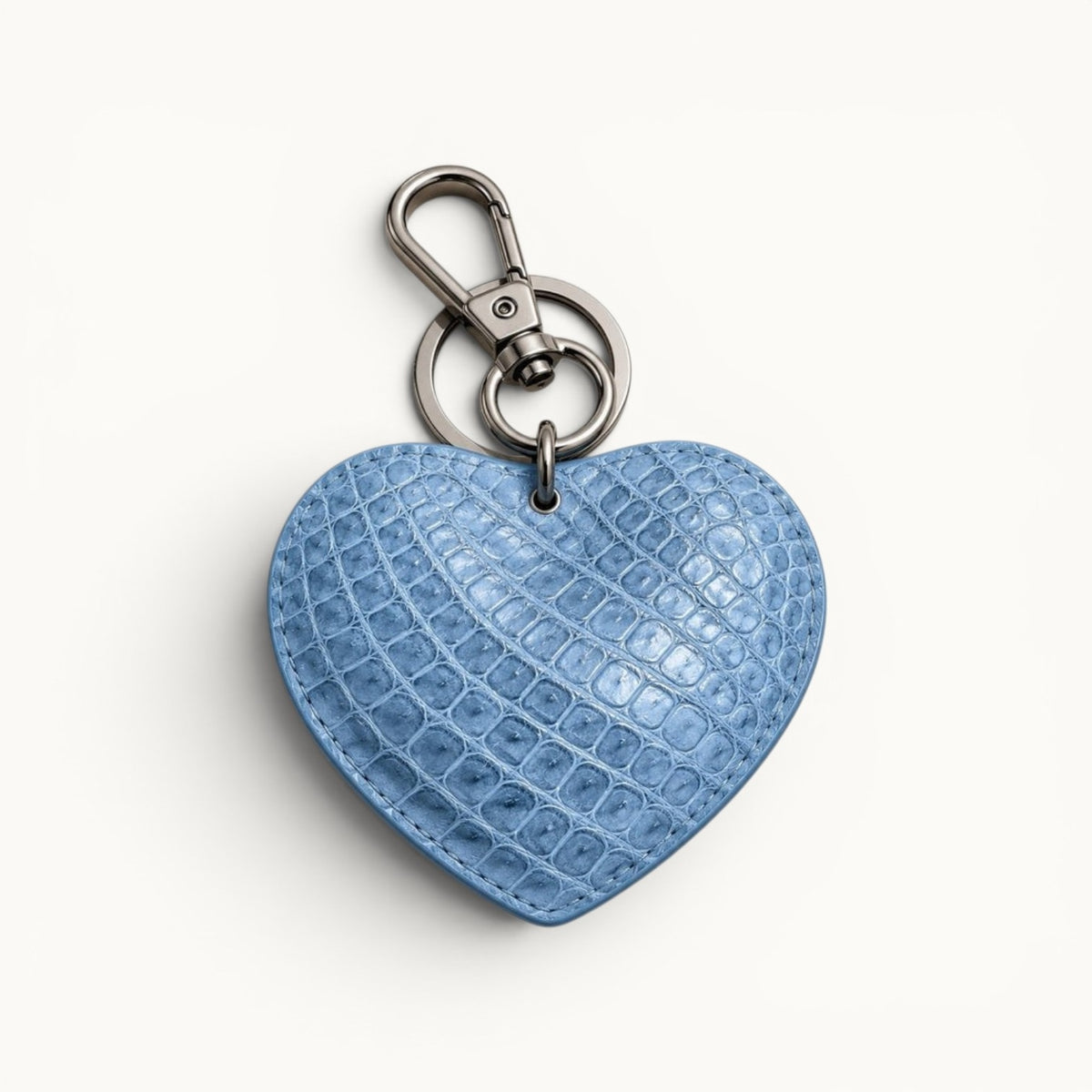 The Heart Key Charm in powder blue Siamese crocodile leather with natural scales and polished silver-tone keyring hardware.