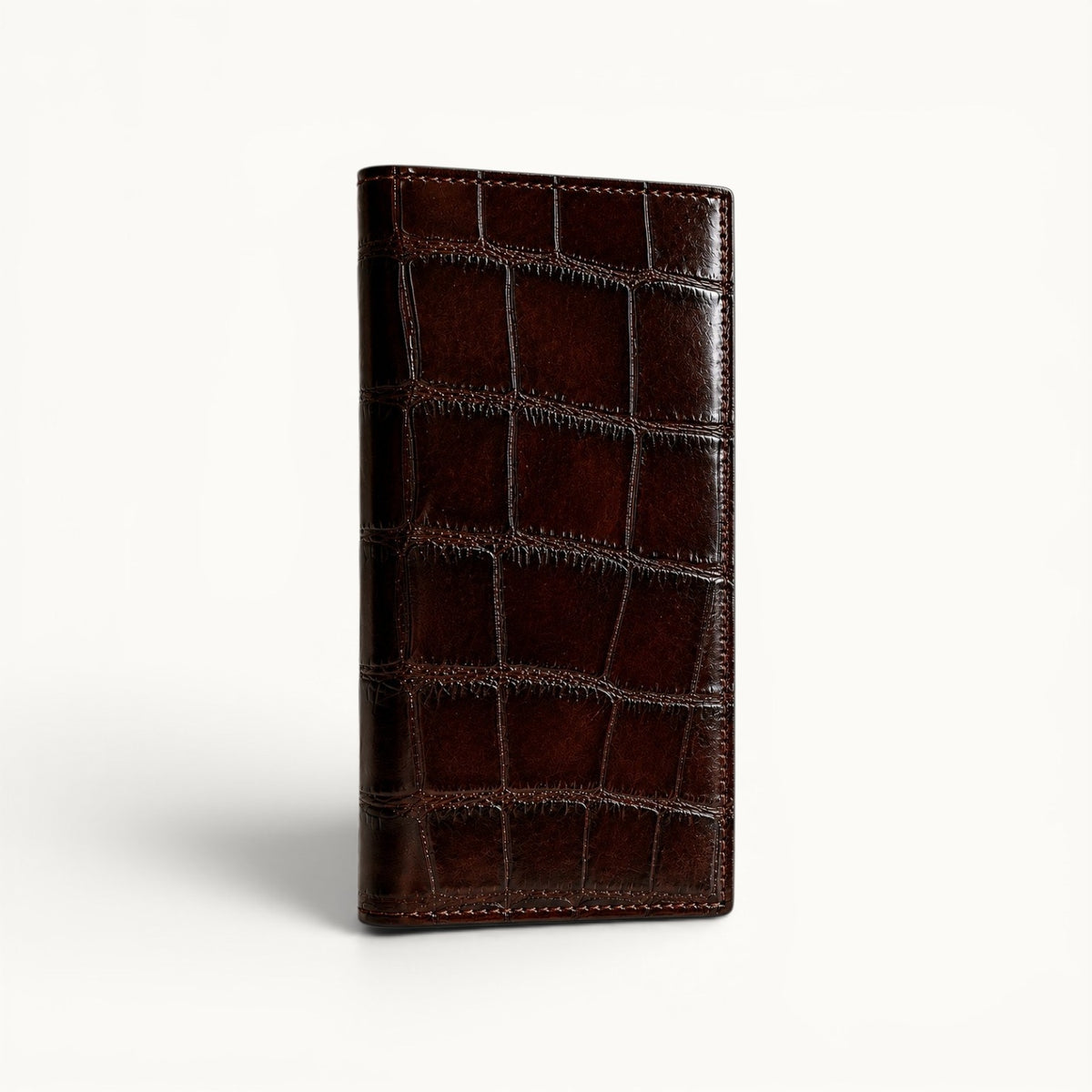 The Kingsley Crocodile Long Wallet in Imperial Mahogany shown in a front angle view highlighting the rich finish and natural crocodile scale pattern.