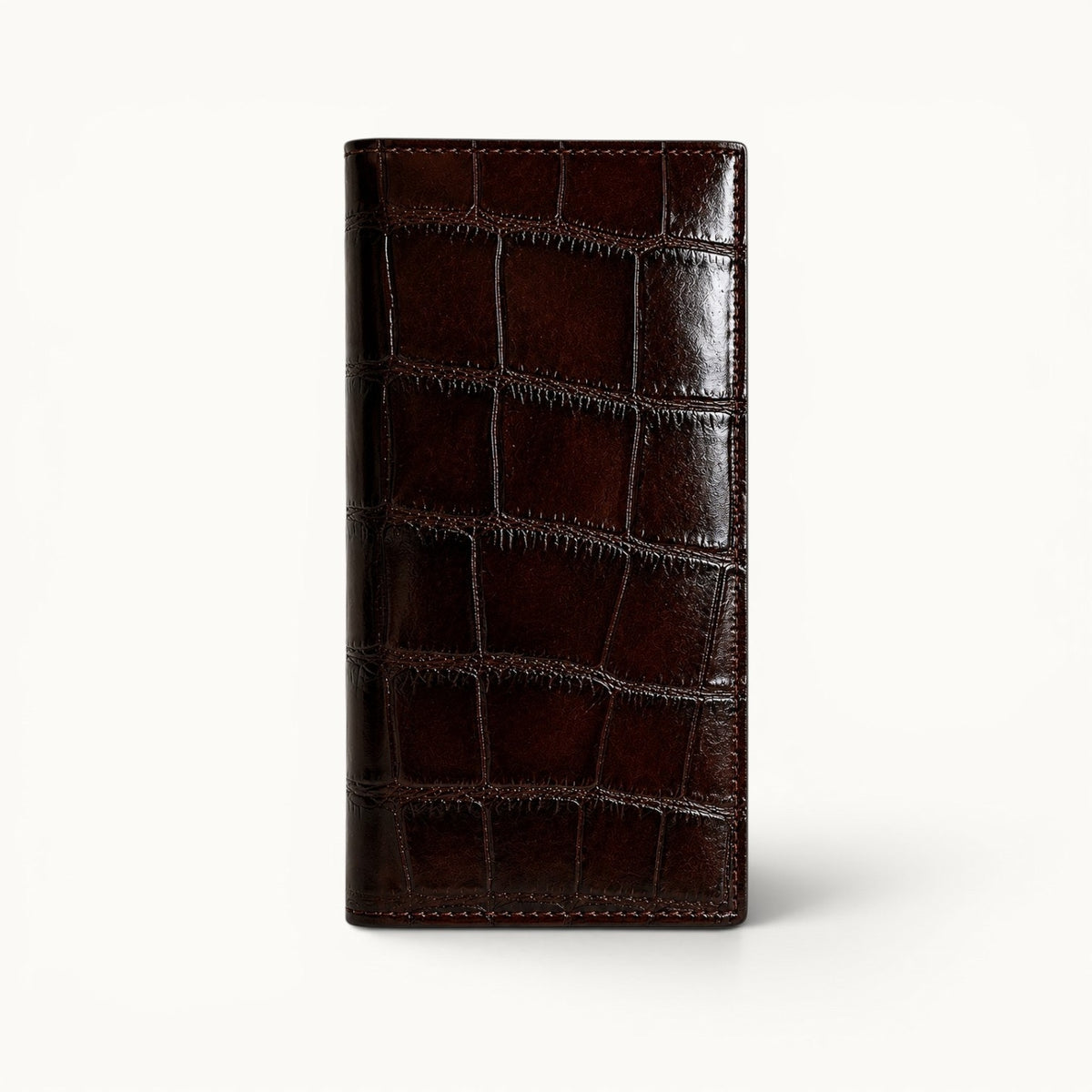 The Kingsley Crocodile Long Wallet in Imperial Mahogany genuine crocodile leather featuring a slim silhouette and natural scale pattern.