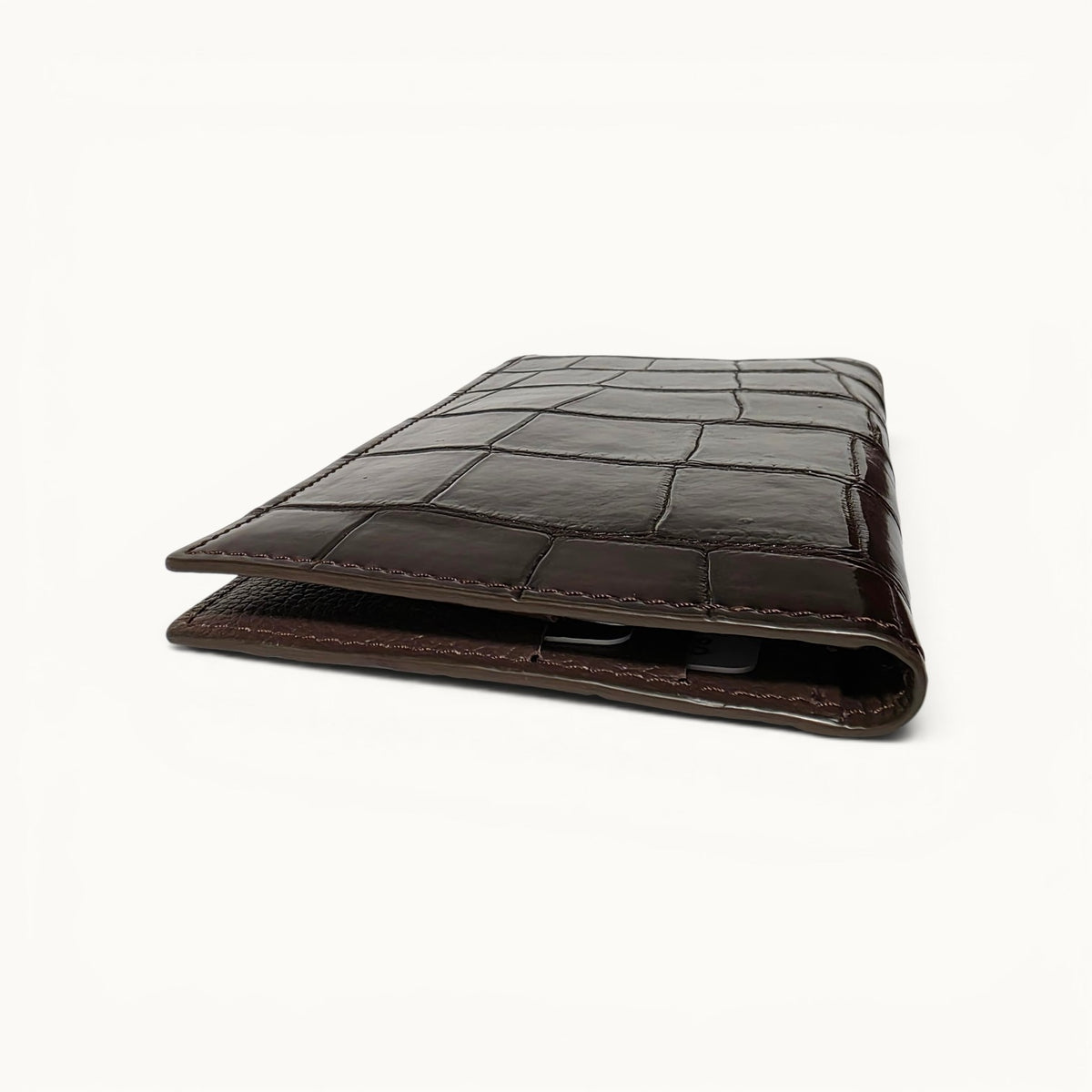 Slim top profile of The Kingsley Crocodile Long Wallet handcrafted from genuine crocodile leather in Imperial Mahogany, highlighting its elegant thin design and interior capacity.