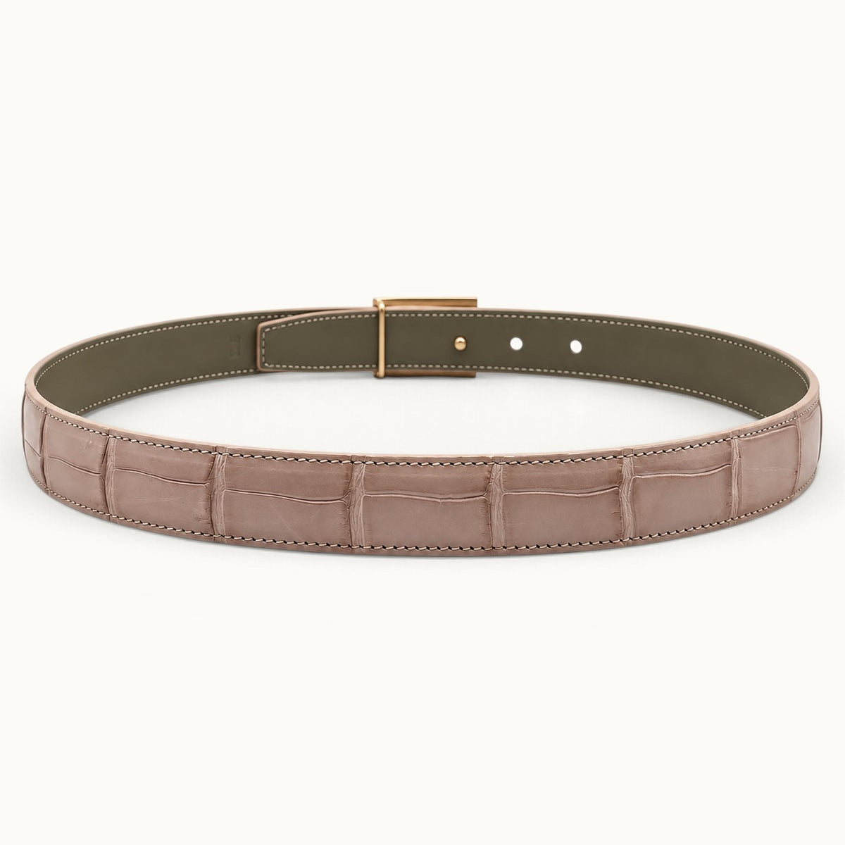 Rear view of The Rosalie Crocodile Belt showing its blush pink crocodile leather exterior, olive-gray interior lining, and gold-tone fastening hardware.