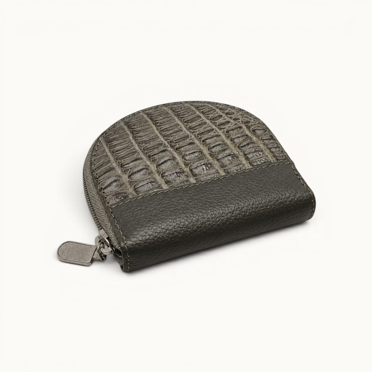Top view of The Sovereign gray crocodile leather mini wallet highlighting its natural scale texture, curved profile, and pebbled leather base.