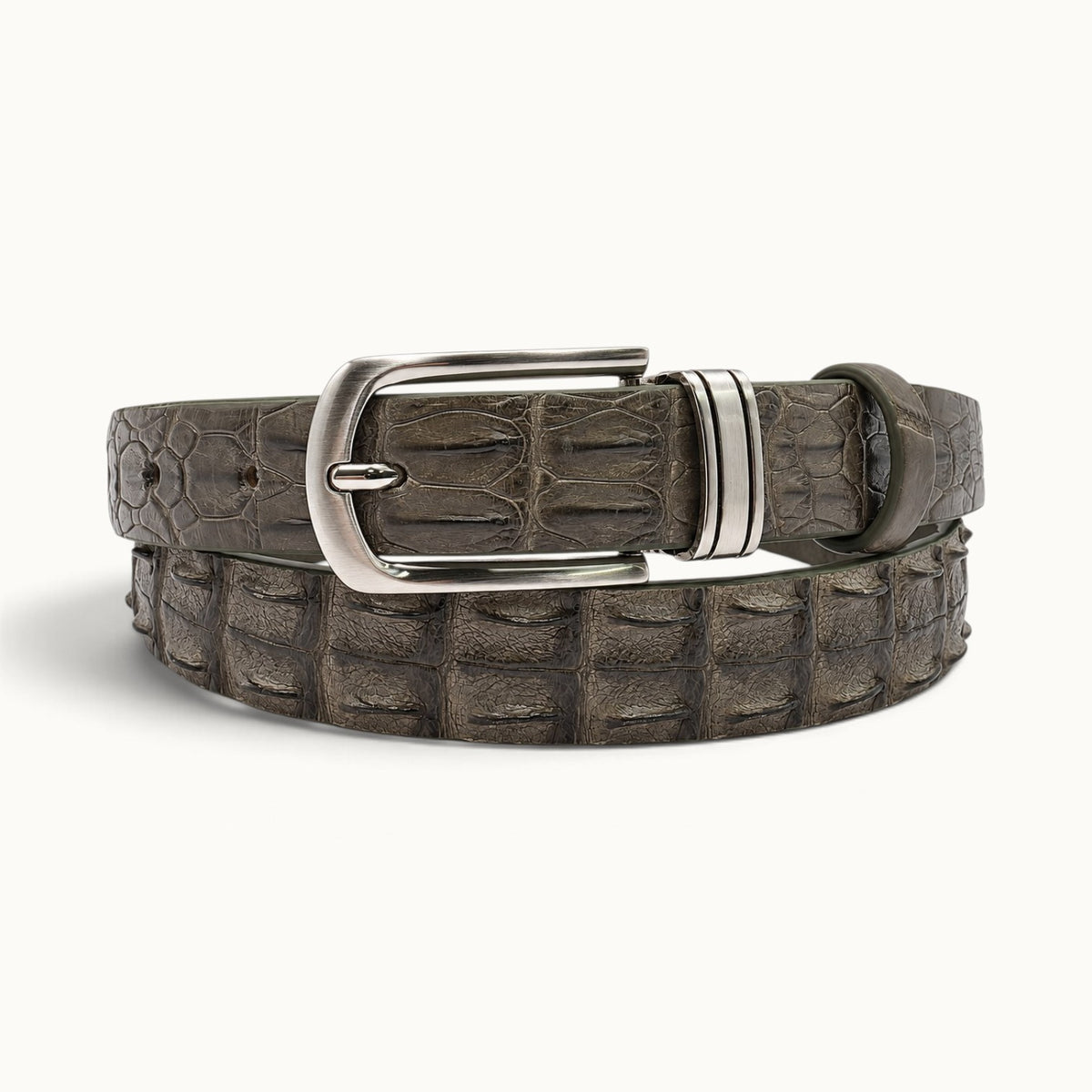 The Waverly Crocodile Belt in Taupe Green, crafted from genuine Siamese crocodile backstrap leather with raised scales and a polished silver-tone buckle.