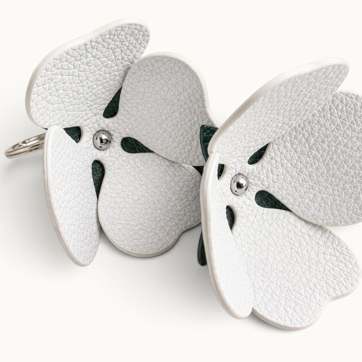 Interior view of the Pearl White Valencia crocodile flower charm showing pebbled cow leather petals and silver-tone hardware